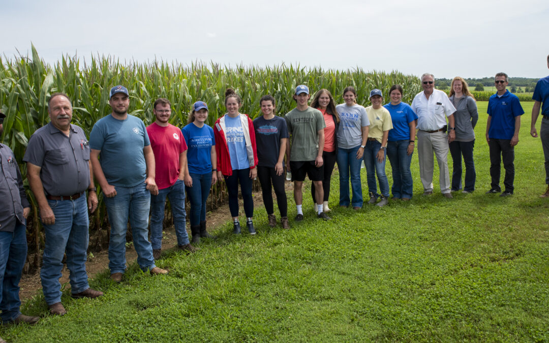 students lined up for a photo in front of a corn field